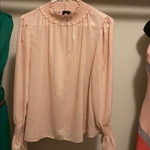 Woman blouse color is BLUSH